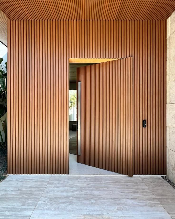 WPC outdoor wood-slat panels at a modern home entrance